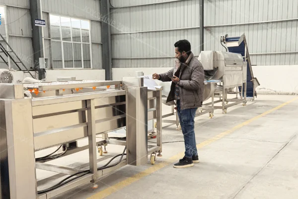 Customer reviewing food-processing equipment at a Joyshine factory visit